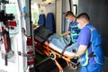 Young paramedics unload a patient from an ambulance