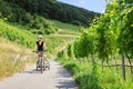 Young Parent Cycling With Bike Trailer