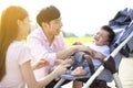 Young parents with baby crying in the carriage Royalty Free Stock Photo