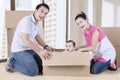 Young parents and child playing with box Royalty Free Stock Photo