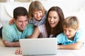 Young parents, with children, on laptop computer Royalty Free Stock Photo