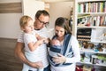 Young parents with children in sling and baby carrier Royalty Free Stock Photo