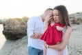 Young parents with cute baby girl outdoors on the beach Royalty Free Stock Photo