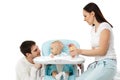 Young parents feed baby. Royalty Free Stock Photo