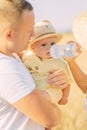 Parents feed their baby from feeding-bottle while outing Royalty Free Stock Photo