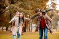 Young parents giving their children a piggyback ride in an Royalty Free Stock Photo