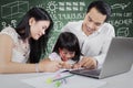 Young parents help their kid studying Royalty Free Stock Photo