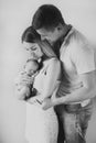 Young parents hold their newborn daughter