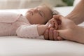 Young parents holding tiny hand of adorable baby girl Royalty Free Stock Photo