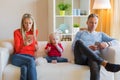 Young parents ignore their kid and looking at their mobile phones Royalty Free Stock Photo