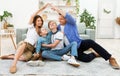 Young parents joining hands making roof sitting with children indoor Royalty Free Stock Photo