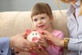 Young parents and little child girl are holding piggy bank Royalty Free Stock Photo