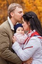 Mom and dad holding baby girl in hands Royalty Free Stock Photo