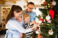 Young parents with two children at Christmas time. Royalty Free Stock Photo