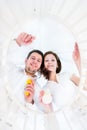 Young parents looking at their baby in a round crib Royalty Free Stock Photo