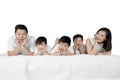 Young parents lying with their son on studio Royalty Free Stock Photo