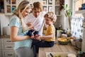 Young parents with newborn baby and small toddler son at home.