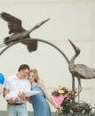 Young parents with a newborn baby standing under the arch near the maternity hospital Royalty Free Stock Photo