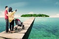 Young parents on the pier with a stroller Royalty Free Stock Photo