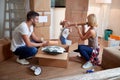 Young parents playing with their minor daughter  in new apartment. new apartment, new beginning, joy concept Royalty Free Stock Photo