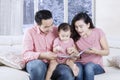 Young parents reading story on book Royalty Free Stock Photo