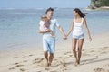young parents and their cute little daughter walking at the beach Royalty Free Stock Photo