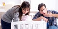 The young parents with their newborn baby near bed cot Royalty Free Stock Photo