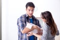 The young parents with their newborn baby near bed cot Royalty Free Stock Photo