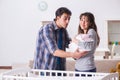 The young parents with their newborn baby near bed cot Royalty Free Stock Photo