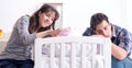 Young parents with their newborn baby near bed cot Royalty Free Stock Photo