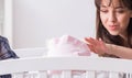 Young parents with their newborn baby near bed cot Royalty Free Stock Photo