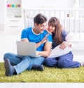 Young parents with their newborn baby sitting on the carpet Royalty Free Stock Photo