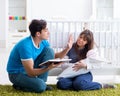 Young parents with their newborn baby sitting on the carpet Royalty Free Stock Photo