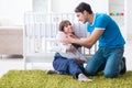 The young parents with their newborn baby sitting on the carpet Royalty Free Stock Photo