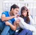 Young parents with their newborn baby sitting on the carpet Royalty Free Stock Photo