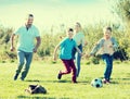 Young parents with two kids playing soccer Royalty Free Stock Photo