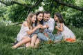 Young parents with two kids tasting cupcakes outdoors Royalty Free Stock Photo