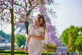 Young Parisian woman near the Eiffel tower in Paris Royalty Free Stock Photo