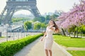 Young Parisian woman near the Eiffel tower in Paris Royalty Free Stock Photo