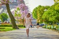 Young Parisian woman near the Eiffel tower in Paris Royalty Free Stock Photo