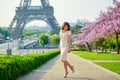 Young Parisian woman near the Eiffel tower in Paris Royalty Free Stock Photo