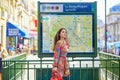 Young Parisian woman near the subway plan Royalty Free Stock Photo