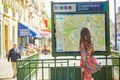 Young Parisian woman near the subway plan Royalty Free Stock Photo