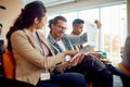 Young participants at a business lecture in the conference room are analyzing writings together. Business, people, company Royalty Free Stock Photo