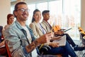 Young participants are enjoying while following a business lecture in the conference room. Business, people, company Royalty Free Stock Photo