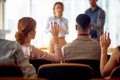 Young participants having questions during a business lecture in the conference room. Business, people, meeting, company