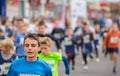 Young participants hurrying to finish line during kids section of `Dnepr Eco Marathon` race