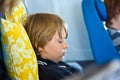 Young passenger sleeping in the aircraft