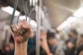 Young passenger woman hand holding Handle on the train or on the bus for safety. Safety travel trip