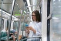 Passenger young woman using mobile smart phone chatting in social networks in subway train at metro Royalty Free Stock Photo